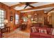 Cozy living room featuring wood paneling, beamed ceilings, chandelier, and beautiful hardwood floors at 643 Longstreet Dr, Marietta, GA 30064
