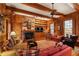 Cozy living room featuring wood paneling, beamed ceilings, brick fireplace, and custom built-ins at 643 Longstreet Dr, Marietta, GA 30064