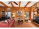 Cozy living room featuring wood paneling, beamed ceilings, brick fireplace, and custom built-ins at 643 Longstreet Dr, Marietta, GA 30064