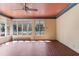 Bright sunroom with brick flooring, large windows offering backyard views and a unique colored ceiling with fan at 643 Longstreet Dr, Marietta, GA 30064