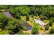 An aerial view of the community pool and playground beside the lake surrounded by a lush green forest at 1203 Bonshaw Trl, Marietta, GA 30064