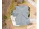 An aerial view shows the home's roof, landscaping, patio and inground spa in a backyard setting at 1203 Bonshaw Trl, Marietta, GA 30064