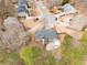 Aerial view of backyard with patio and inground spa with wooded perimeter in established neighborhood at 1203 Bonshaw Trl, Marietta, GA 30064