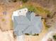 An aerial view shows the home's roof, landscaping, patio and inground spa in a backyard setting at 1203 Bonshaw Trl, Marietta, GA 30064