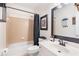 Cozy bathroom with a shower-tub combo, a modern vanity, and a decorative black framed mirror at 1203 Bonshaw Trl, Marietta, GA 30064