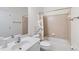 Neutral toned bathroom featuring a shower-tub combo, vanity sink, and tile flooring at 1203 Bonshaw Trl, Marietta, GA 30064