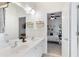 Bright bathroom featuring a double sink vanity, with a view into the bedroom at 1203 Bonshaw Trl, Marietta, GA 30064