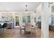 Well lit dining area featuring a modern chandelier and large windows overlooking the backyard at 1203 Bonshaw Trl, Marietta, GA 30064