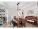 Dining room with modern light fixture, wood table, and hardwood floors at 1203 Bonshaw Trl, Marietta, GA 30064