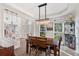 Bright dining room with wood table, statement lighting, and hardwood floors at 1203 Bonshaw Trl, Marietta, GA 30064