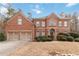 Beautiful two-story brick home with a well-manicured lawn and two-car garage at 1203 Bonshaw Trl, Marietta, GA 30064