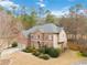 Aerial view of a brick home with lush landscaping, mature trees, and large driveway at 1203 Bonshaw Trl, Marietta, GA 30064