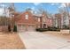 Charming two-story brick home featuring a spacious driveway and lush front yard at 1203 Bonshaw Trl, Marietta, GA 30064