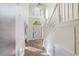 Light-filled foyer with a soaring ceiling and a view of the front door and staircase at 1203 Bonshaw Trl, Marietta, GA 30064