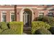 Close-up of the entrance with an arched doorway and well-maintained landscaping at 1203 Bonshaw Trl, Marietta, GA 30064