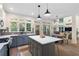 Open floorplan kitchen with island, stainless appliances, quartz countertops, and eat-in dining area at 1203 Bonshaw Trl, Marietta, GA 30064