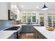 Bright kitchen features white and gray cabinets, stainless appliances, quartz countertops, and large windows at 1203 Bonshaw Trl, Marietta, GA 30064