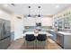 Modern kitchen with stainless steel appliances, island with seating, and stylish gray cabinetry at 1203 Bonshaw Trl, Marietta, GA 30064