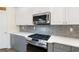 Modern kitchen with stainless steel appliances, tile backsplash, and white countertops at 1203 Bonshaw Trl, Marietta, GA 30064