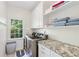 Laundry room with white cabinets, granite countertops, washer and dryer at 1203 Bonshaw Trl, Marietta, GA 30064