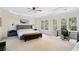 Spacious primary bedroom with tray ceiling, large windows, and room for an office space at 1203 Bonshaw Trl, Marietta, GA 30064