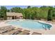 Community pool area featuring lounge chairs, umbrellas, and multiple seating areas at 1203 Bonshaw Trl, Marietta, GA 30064
