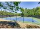 Tennis courts with fenced enclosure, and a spectator bench near the play area at 1203 Bonshaw Trl, Marietta, GA 30064
