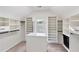 Spacious walk-in closet with custom built-in shelving and natural light at 1203 Bonshaw Trl, Marietta, GA 30064