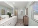 Well-lit bathroom features double vanity with modern fixtures, neutral colors, and a large mirror at 218 Highgrove Way, Dallas, GA 30157