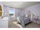 Charming bedroom featuring a stylish canopy bed, soft carpet, and a well-lit window at 218 Highgrove Way, Dallas, GA 30157
