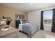 Well-lit bedroom with modern decor, a cozy bed, and a large window at 218 Highgrove Way, Dallas, GA 30157