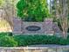 Palisades community entrance with brick signage surrounded by lush landscaping at 218 Highgrove Way, Dallas, GA 30157