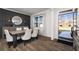 Formal dining room features wainscoting, a large window, modern lighting, and sleek hardwood floors at 218 Highgrove Way, Dallas, GA 30157