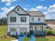 Charming two-story home boasts stone accents, a covered entryway, and attached two-car garage at 218 Highgrove Way, Dallas, GA 30157