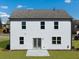 Rear exterior featuring a two-story home with a well-kept lawn and double doors at 218 Highgrove Way, Dallas, GA 30157