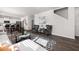 Open-concept living area with eat-in kitchen, comfortable seating, and hardwood floors at 218 Highgrove Way, Dallas, GA 30157