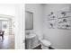 Modern powder room showcasing elegant vanity, decorative wall art, and sleek hardwood floors at 218 Highgrove Way, Dallas, GA 30157
