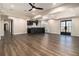 Spacious basement with a bar area, ceiling fan, and beautiful dark wood-look floors at 490 Revenna Trl, Fayetteville, GA 30214