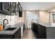 Close-up of basement bar area features dark cabinets, marble backsplash, and ample counter space at 490 Revenna Trl, Fayetteville, GA 30214