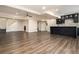 Open basement area features bar with dark cabinetry and light countertops at 490 Revenna Trl, Fayetteville, GA 30214
