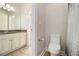 Bathroom features vanity with granite countertop, toilet, and natural light at 490 Revenna Trl, Fayetteville, GA 30214