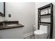 Neutral bathroom features modern sink, toilet and shelving at 490 Revenna Trl, Fayetteville, GA 30214