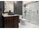 Modern bathroom features patterned bowl sink, dark vanity, and glass-enclosed shower at 490 Revenna Trl, Fayetteville, GA 30214