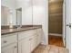 Well-lit bathroom features a vanity with granite countertop and walk-in closet at 490 Revenna Trl, Fayetteville, GA 30214