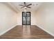 Bedroom featuring dark french doors, wood-look flooring, and neutral walls at 490 Revenna Trl, Fayetteville, GA 30214