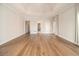 Bright and airy bedroom features hardwood floors and multiple entry doors at 490 Revenna Trl, Fayetteville, GA 30214