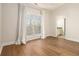Bright bedroom features hardwood floors, a large window, and an en-suite bathroom at 490 Revenna Trl, Fayetteville, GA 30214