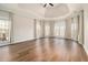 Large bedroom boasts hardwood floors, tray ceiling, and sun-drenched windows at 490 Revenna Trl, Fayetteville, GA 30214