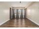Bright bedroom has wood-look flooring, neutral walls, and large windows at 490 Revenna Trl, Fayetteville, GA 30214