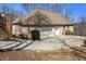 Brick home with a three car garage, concrete driveway, and landscaping at 490 Revenna Trl, Fayetteville, GA 30214